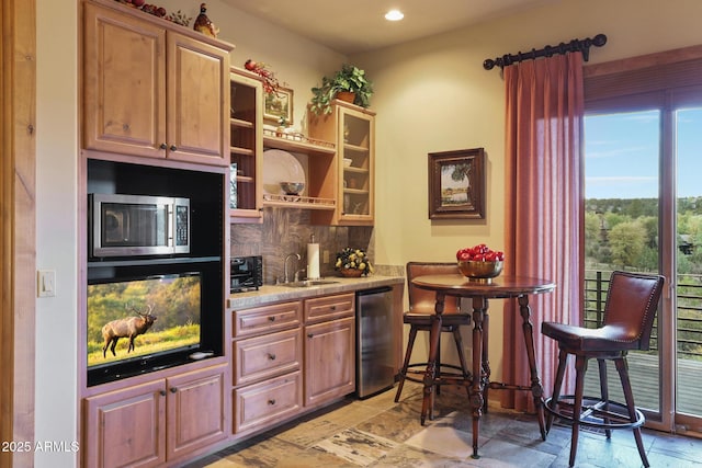 2800 E Morning Glory Cir, Payson, AZ 85541 - kitchen featuring stainless steel microwave, beverage cooler, a sink, decorative backsplash, and stone tile floors