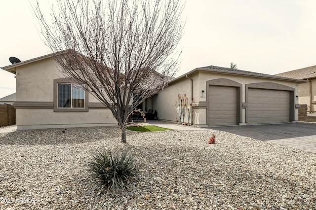 6215 E Sefton Dr, Prescott Valley, AZ 86314 - view of front of house featuring stucco siding, a garage, and decorative driveway