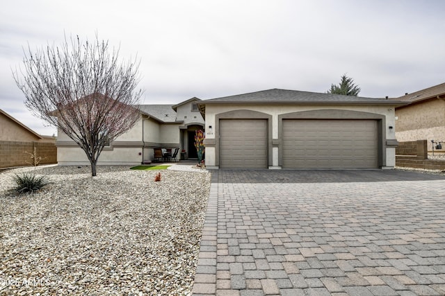 6215 E Sefton Dr, Prescott Valley, AZ 86314 - ranch-style home featuring stucco siding, an attached garage, fence, and decorative driveway