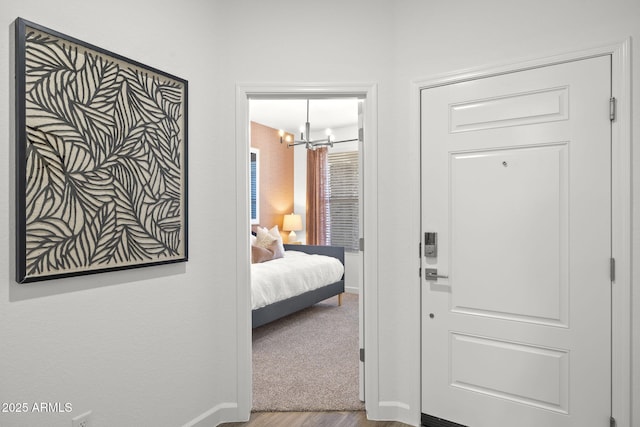 bedroom featuring wood-type flooring and a chandelier