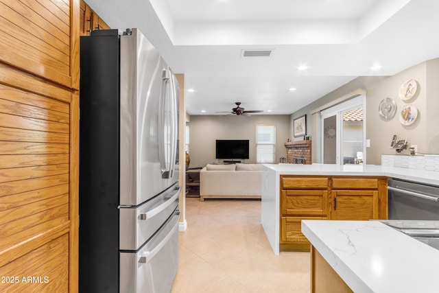 kitchen featuring light tile patterned flooring, ceiling fan, stainless steel appliances, open floor plan, and visible vents