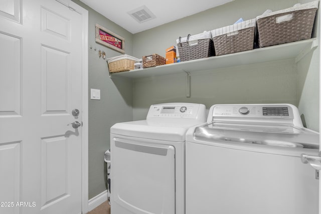 laundry area featuring laundry area, baseboards, visible vents, and washing machine and clothes dryer