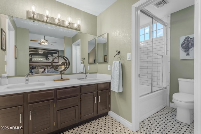 bathroom featuring a sink, a ceiling fan, toilet, and visible vents