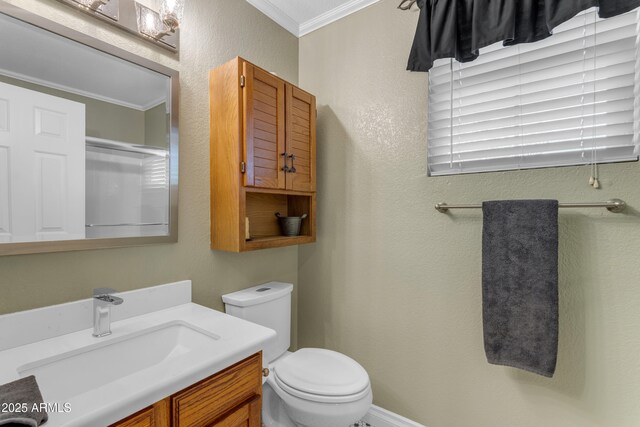 bathroom featuring vanity, ornamental molding, and toilet