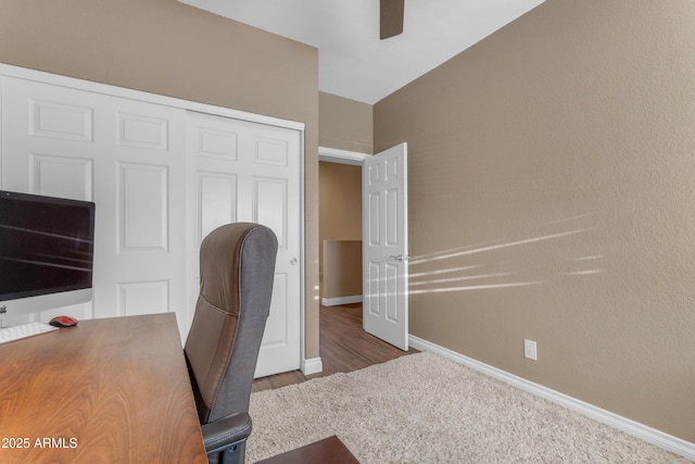 unfurnished office featuring baseboards, a ceiling fan, and wood finished floors