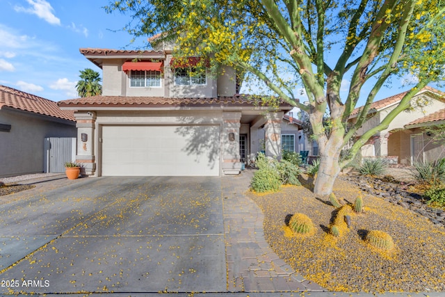 view of front of property featuring a garage, stucco siding, driveway, and a tile roof