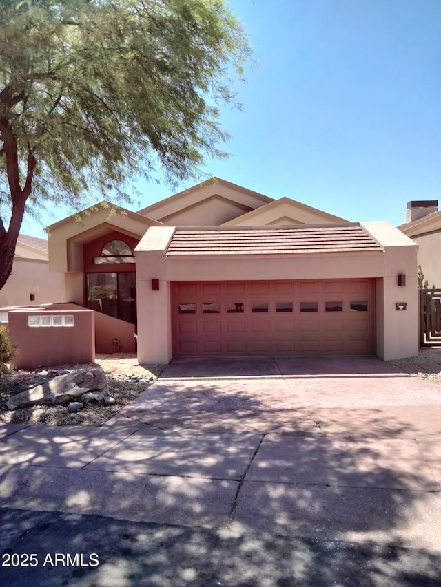 25150 N Windy Walk Dr Unit 14, Scottsdale, AZ 85255 - view of front of house with an attached garage, driveway, and stucco siding