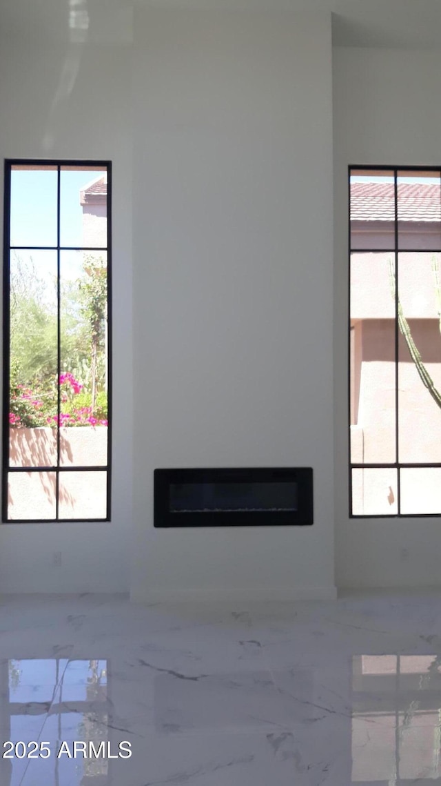 25150 N Windy Walk Dr Unit 14, Scottsdale, AZ 85255 - unfurnished living room with a glass covered fireplace and marble tiled floors