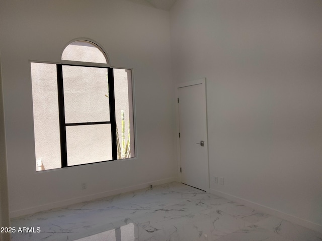 25150 N Windy Walk Dr Unit 14, Scottsdale, AZ 85255 - spare room with light marble finish floors and a high ceiling
