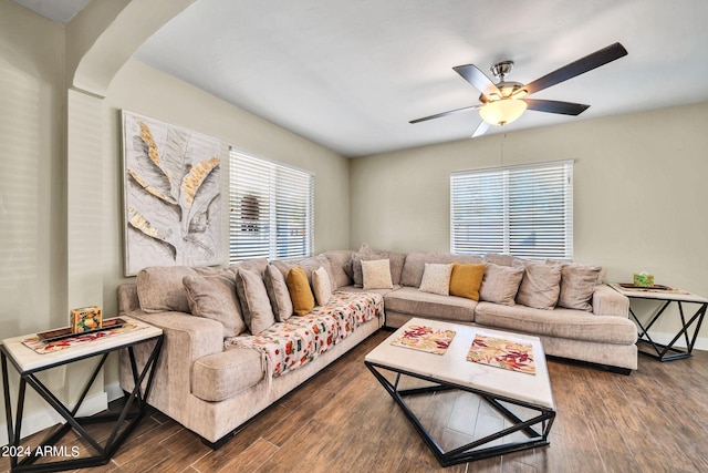 living room featuring dark hardwood / wood-style floors, ceiling fan, and a wealth of natural light