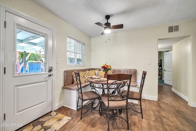 dining area with dark hardwood / wood-style floors and ceiling fan