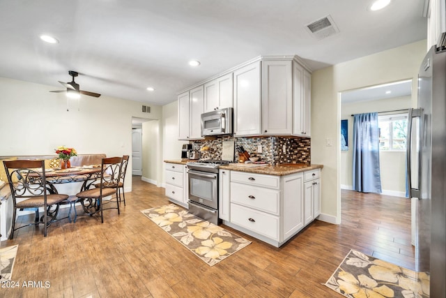 kitchen featuring light hardwood / wood-style floors, stainless steel appliances, and white cabinets