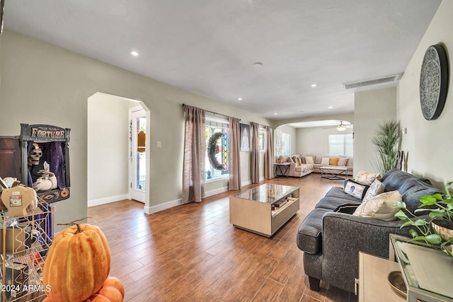 living room featuring wood-type flooring and ceiling fan