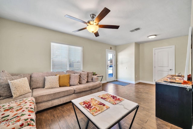 living room featuring ceiling fan and hardwood / wood-style flooring