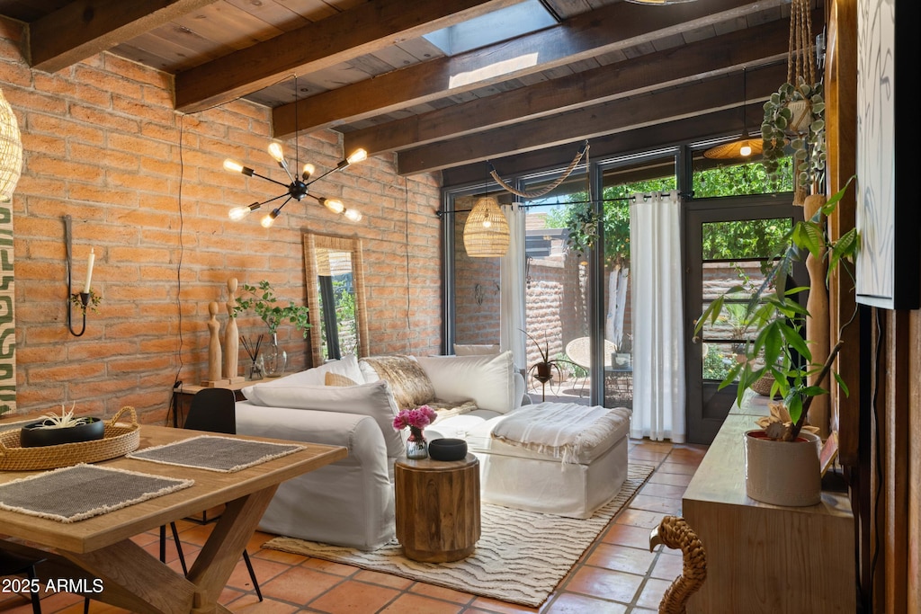 3032 N 32nd St Unit 61, Phoenix, AZ 85018 - tiled living room featuring brick wall, a wood ceiling with exposed beams, a chandelier, and a skylight