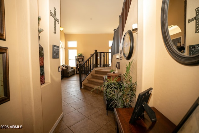 corridor with dark tile patterned floors and stairs