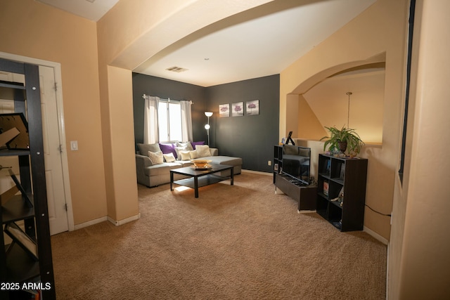 carpeted living area with visible vents and baseboards