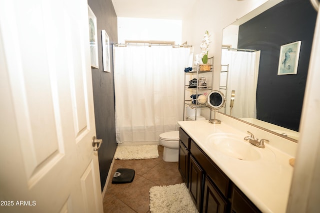 bathroom with toilet, a shower with curtain, vanity, and tile patterned floors