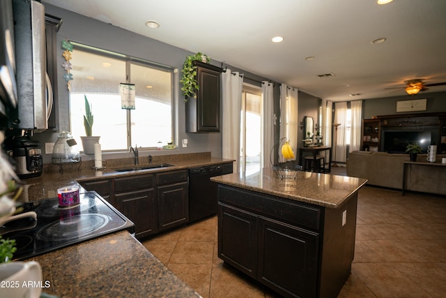 kitchen featuring a sink, visible vents, black dishwasher, open floor plan, and a center island