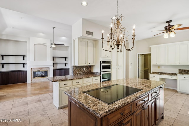 12183 E Mercer Ln, Scottsdale, AZ 85259 - kitchen with a ceiling fan, black electric stovetop, white double oven, a kitchen island, and recessed lighting