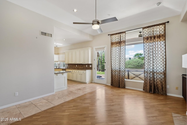 12183 E Mercer Ln, Scottsdale, AZ 85259 - unfurnished living room featuring light wood-type flooring, ceiling fan, baseboards, and recessed lighting