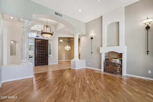 12183 E Mercer Ln, Scottsdale, AZ 85259 - foyer entrance with ornate columns, wood finished floors, arched walkways, baseboards, and recessed lighting