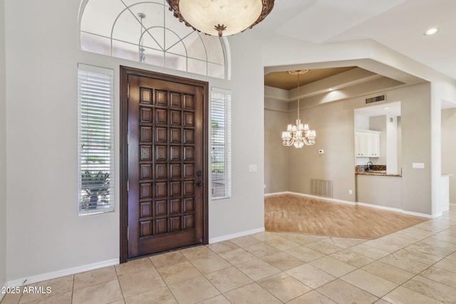 12183 E Mercer Ln, Scottsdale, AZ 85259 - entrance foyer with a chandelier, a raised ceiling, baseboards, and recessed lighting