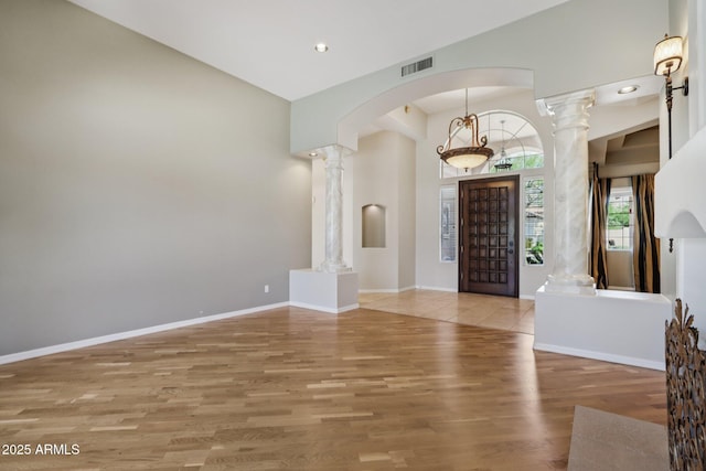 12183 E Mercer Ln, Scottsdale, AZ 85259 - foyer featuring ornate columns, wood finished floors, recessed lighting, arched walkways, and baseboards