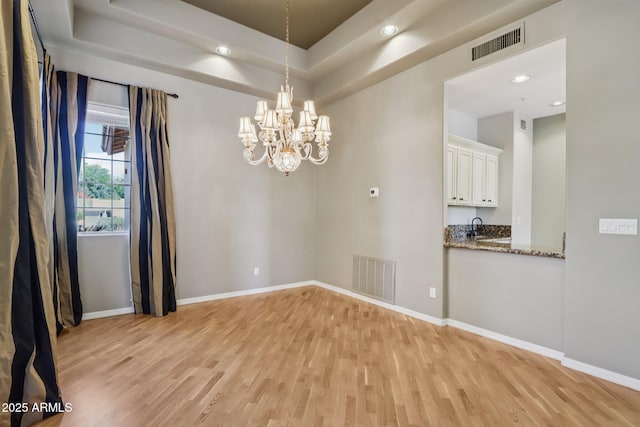 12183 E Mercer Ln, Scottsdale, AZ 85259 - unfurnished room with light wood-type flooring, a chandelier, baseboards, and recessed lighting