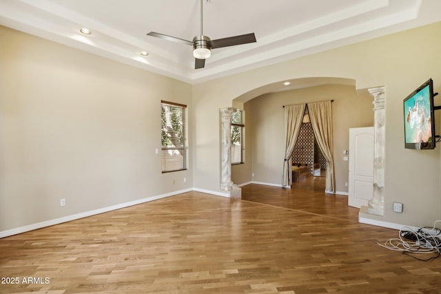 12183 E Mercer Ln, Scottsdale, AZ 85259 - unfurnished room featuring arched walkways, recessed lighting, ornate columns, ceiling fan, and wood finished floors