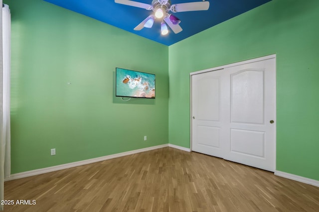 12183 E Mercer Ln, Scottsdale, AZ 85259 - unfurnished bedroom with baseboards, wood finished floors, and a closet