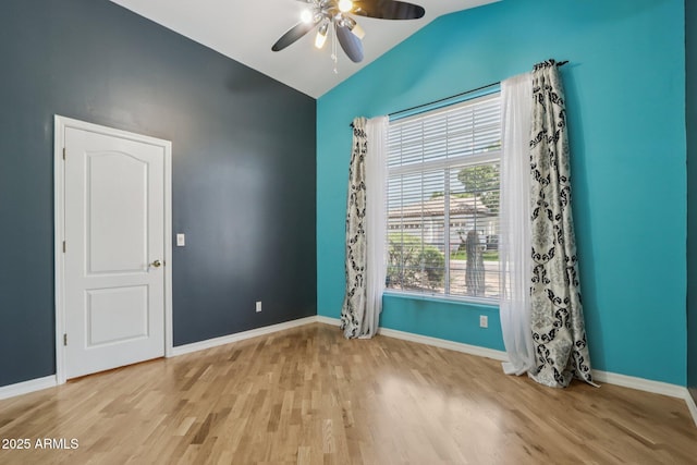 12183 E Mercer Ln, Scottsdale, AZ 85259 - unfurnished room with vaulted ceiling, wood finished floors, ceiling fan, and baseboards