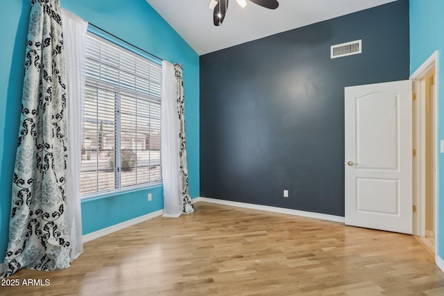 12183 E Mercer Ln, Scottsdale, AZ 85259 - unfurnished room with ceiling fan, wood finished floors, vaulted ceiling, and baseboards