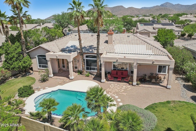 12183 E Mercer Ln, Scottsdale, AZ 85259 - back of house featuring a patio area, a chimney, stucco siding, a tile roof, and a mountain view