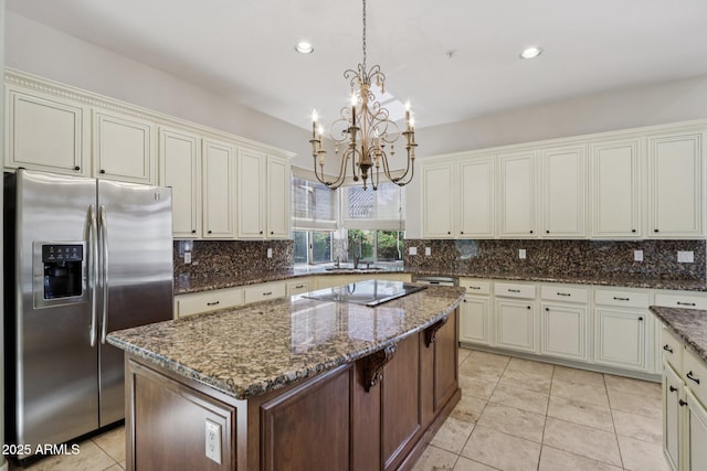 12183 E Mercer Ln, Scottsdale, AZ 85259 - kitchen with stainless steel refrigerator with ice dispenser, a chandelier, black electric cooktop, decorative backsplash, and recessed lighting