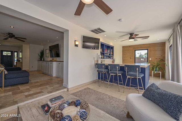 living room with wooden walls and indoor bar