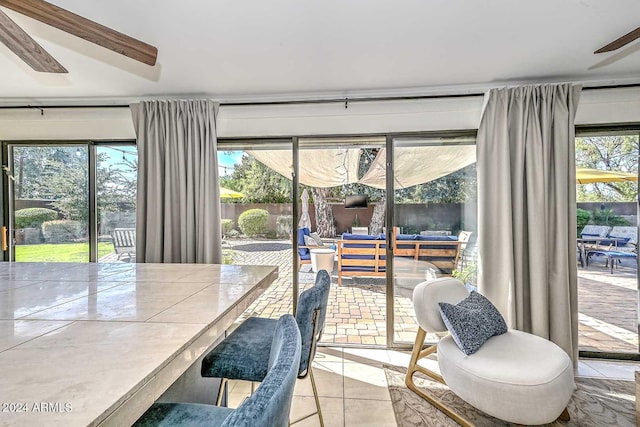 tiled dining area with ceiling fan