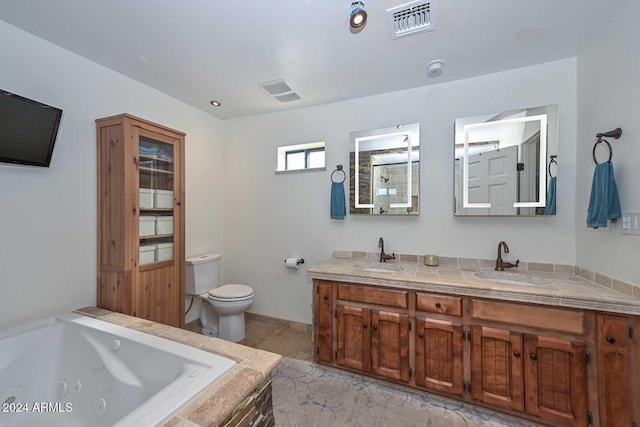 bathroom featuring vanity, toilet, and tiled tub