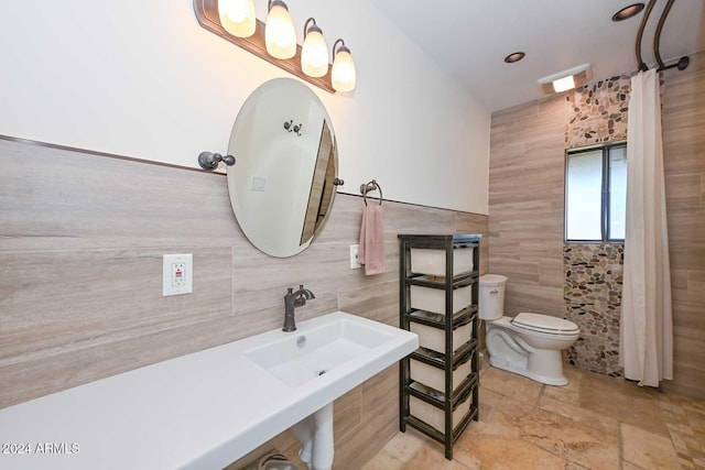 bathroom with tile walls and toilet