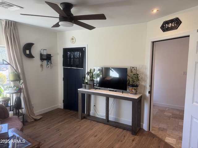 living room featuring ceiling fan and wood-type flooring