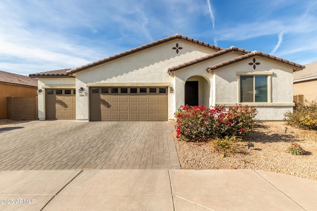 mediterranean / spanish-style home with a garage