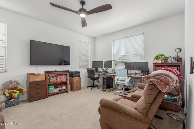 office space featuring ceiling fan and light colored carpet