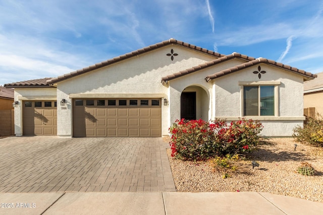 mediterranean / spanish house with a garage