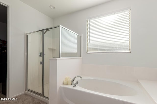 bathroom featuring separate shower and tub