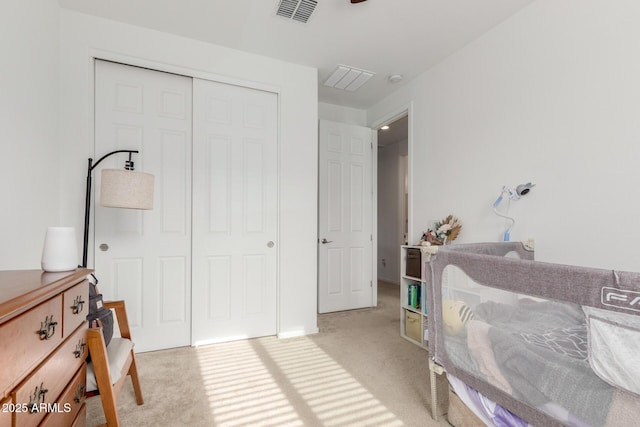 bedroom featuring a closet and light colored carpet