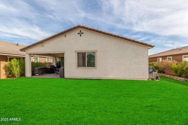 rear view of property with a patio area and a lawn