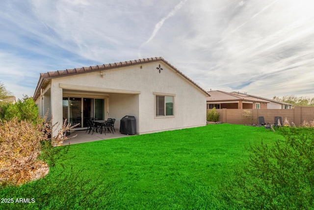 rear view of property with a patio area and a lawn