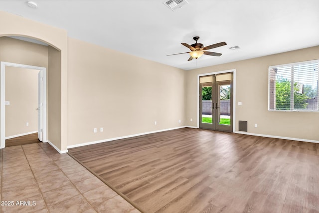 209 E Diamond Trl, San Tan Valley, AZ 85143 - spare room featuring ceiling fan, arched walkways, baseboards, and wood finished floors