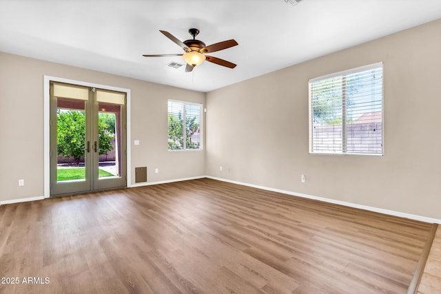 209 E Diamond Trl, San Tan Valley, AZ 85143 - spare room with baseboards, wood finished floors, a ceiling fan, and french doors
