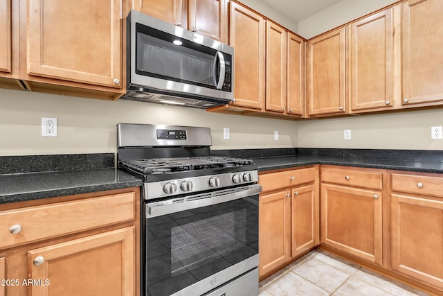 209 E Diamond Trl, San Tan Valley, AZ 85143 - kitchen with stainless steel appliances, light tile patterned floors, and dark stone countertops